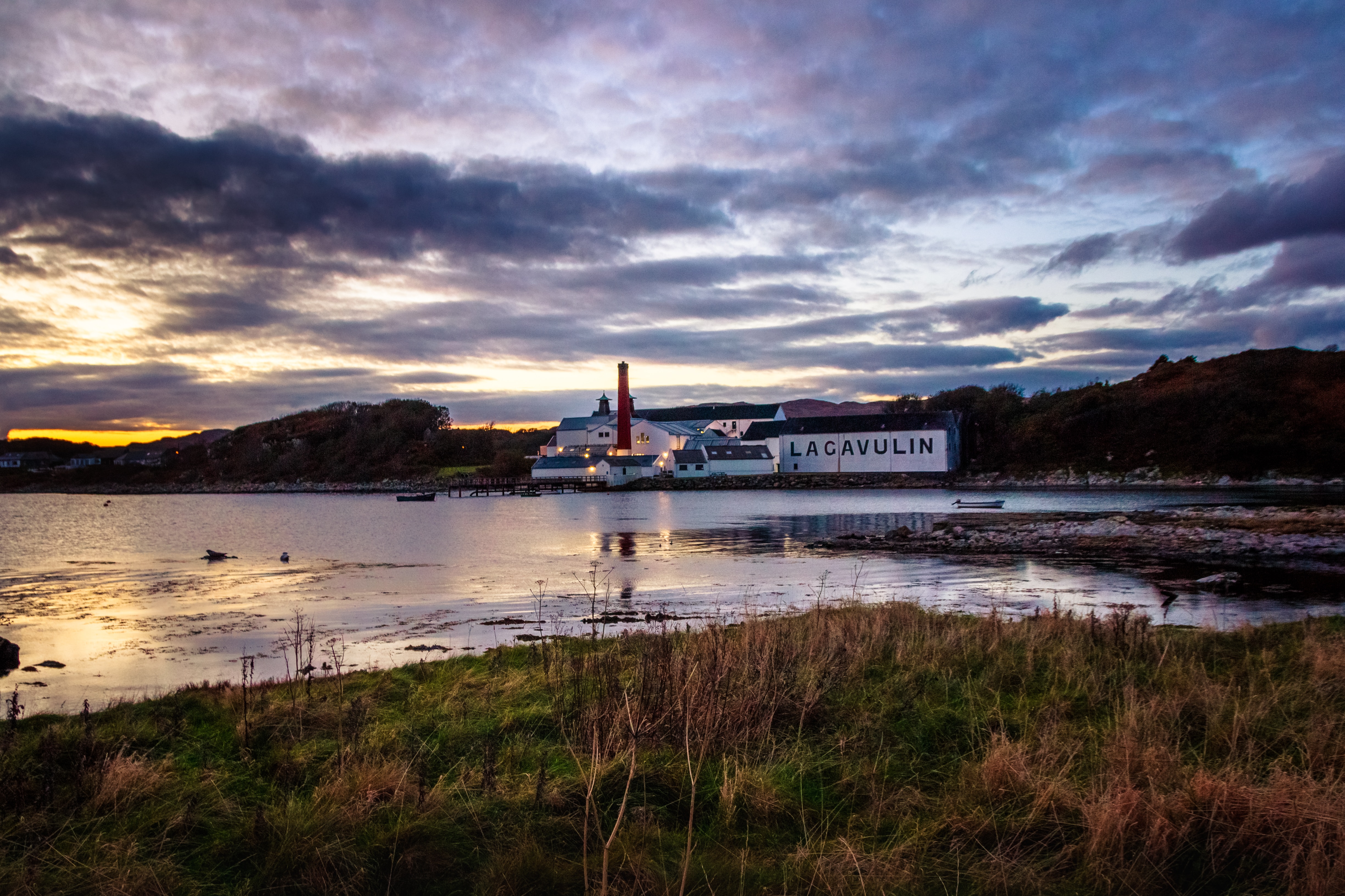 Lagavulin Distillery across the bay at sunset